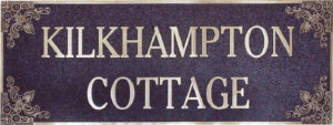 Custom bronze house plaque reading &ldquo;Kilkhampton Cottage,&rdquo; designed for outdoor mounting on heritage homes.