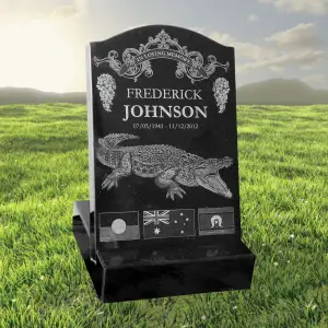 Laser-etched black granite mini headstone featuring detailed crocodile engraving, floral scrollwork, national flags, and a personalized inscription for Frederick Johnson – ideal for unique memorial tributes and custom-designed grave markers.
